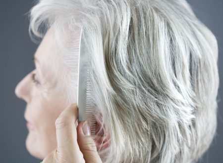 Senior woman combing her hair